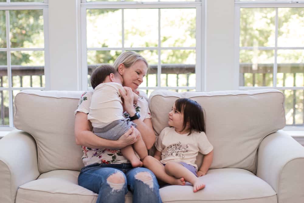 42 Motivating Quotes about Overcoming Challenges 3 lifestyle blogger Amanda Seghetti on couch with babies