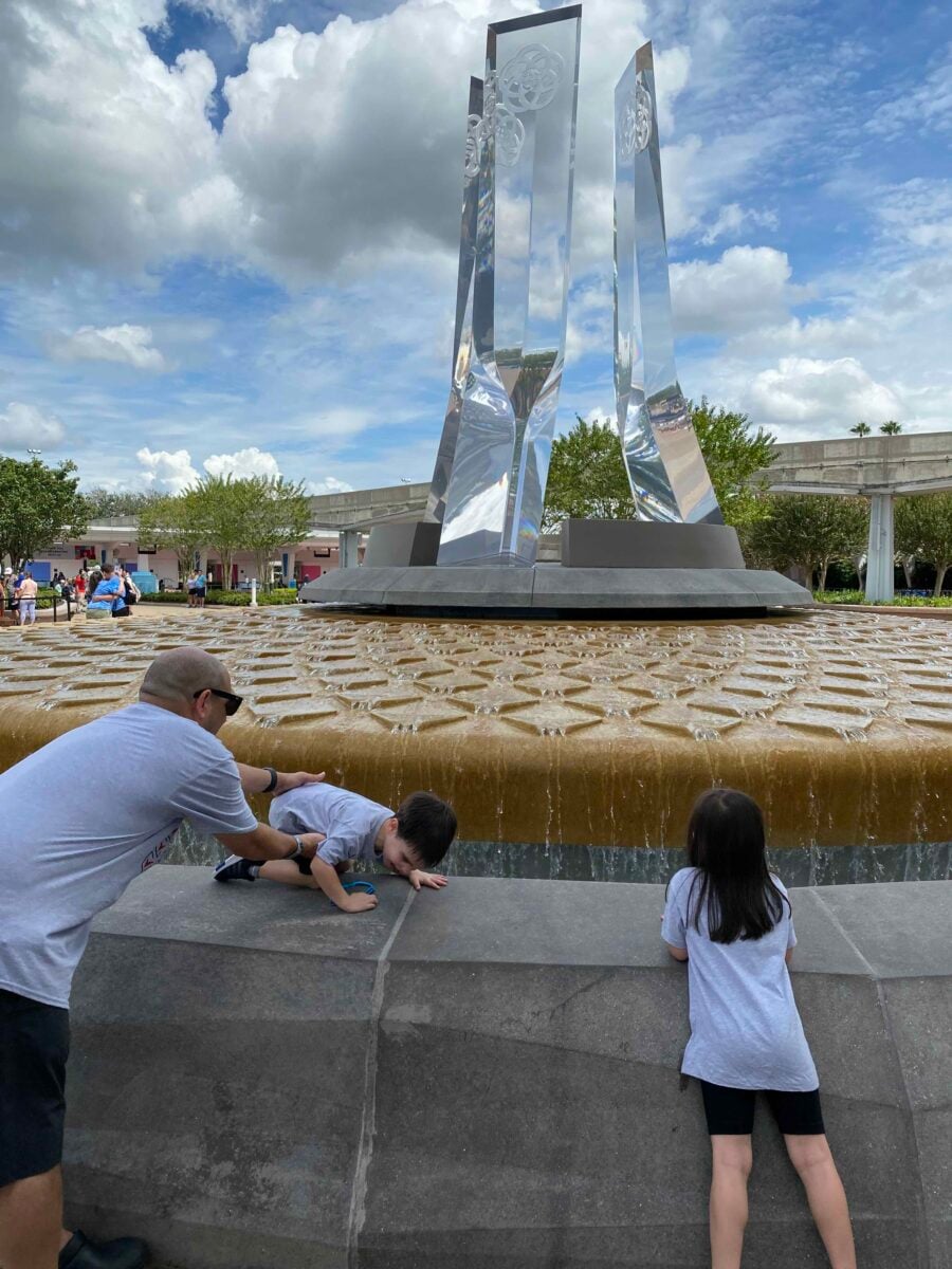 Why We Stopped Eating Artificial Food Dyes (And What Happened) 3 dad stopping little boy from jumping into fountain at Epcot Orlando